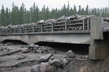 During the 2006 debris flows, the old White River Bridge was completely inundated, leaving an eight-foot layer of boulders on the bridge (ODOT)