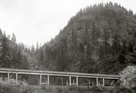 Completed McCord Creek bridge in 1915, with the Kelly pulp mill conduits visible in the cliffs high above, and Elowah Falls behind the bridge