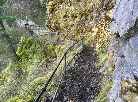 The catwalk section has reassuring railing atop the 300-foot cliffs