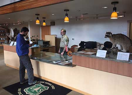 Rangers staff the new front desk at the visitors center